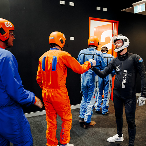 An instructor fist-bumping a flyer after the flight session