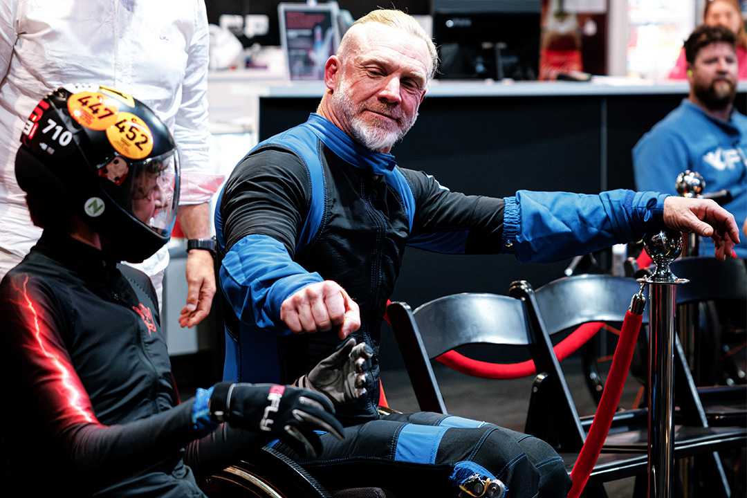 Flyers in flight suits preparing beside the wind tunnel