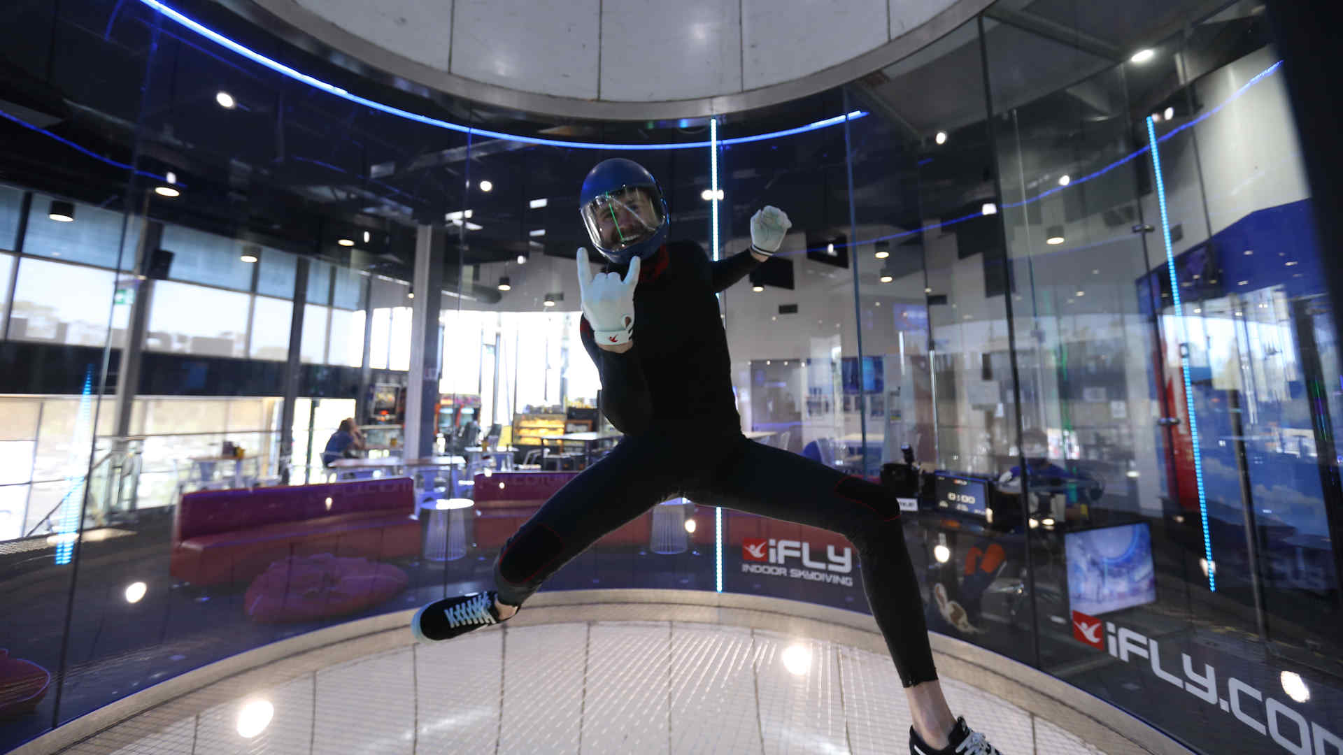 Man flying in tunnel giving the rock on hand signal