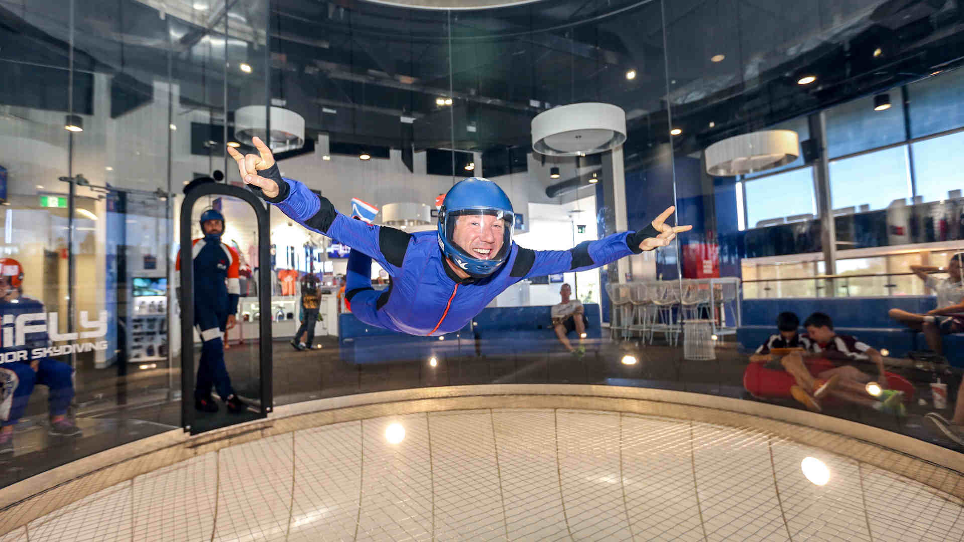 Man flying in tunnel in a blue jumpsuit